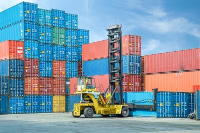 A pile of containers with a forklift