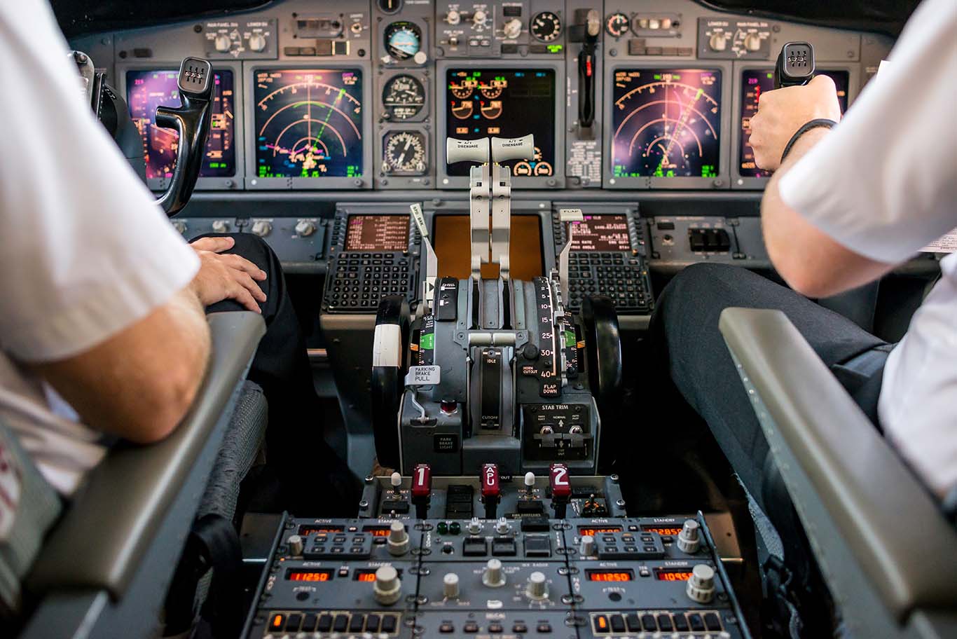 copilot's hands on a cockpit